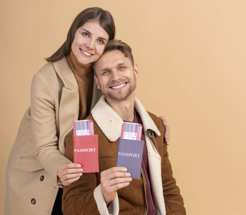 young-couple-posing-together-with-passport-plane-tickets