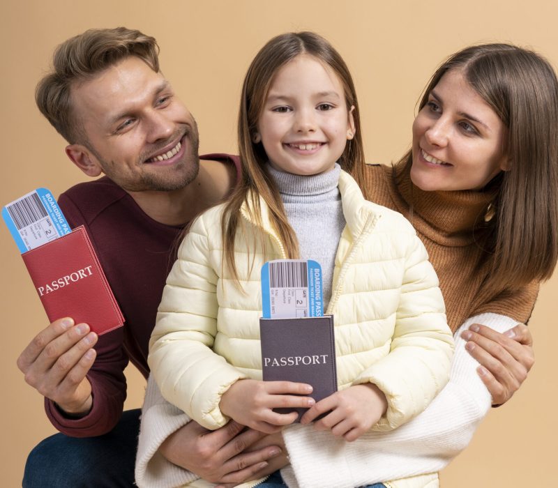 young-family-three-posing-together-before-travel-vacation