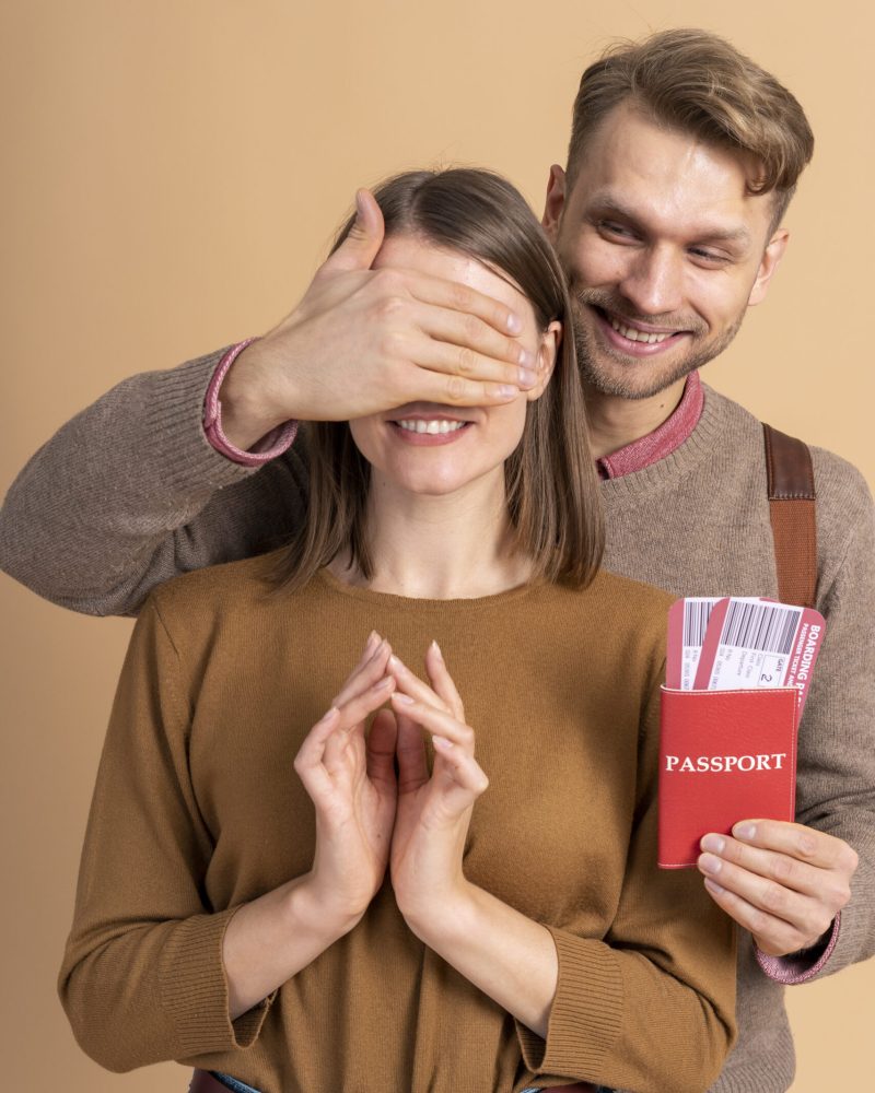 young-man-surprising-girlfriend-with-passport-plane-tickets-traveling